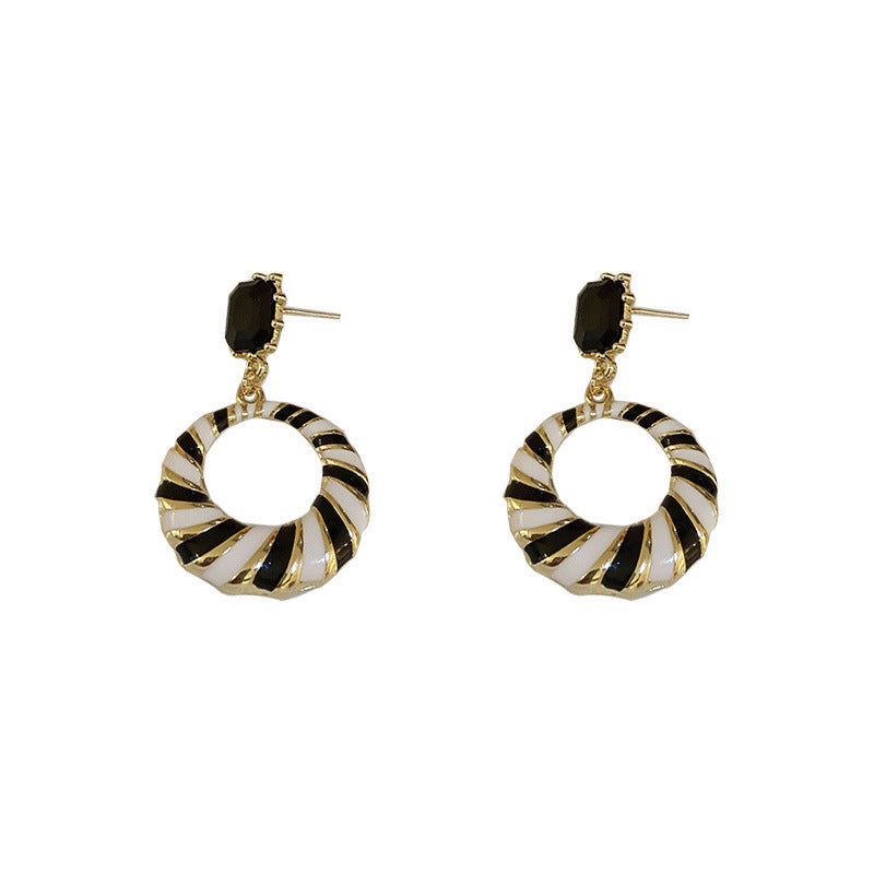 Pair of hoop earrings with black and gold striped design