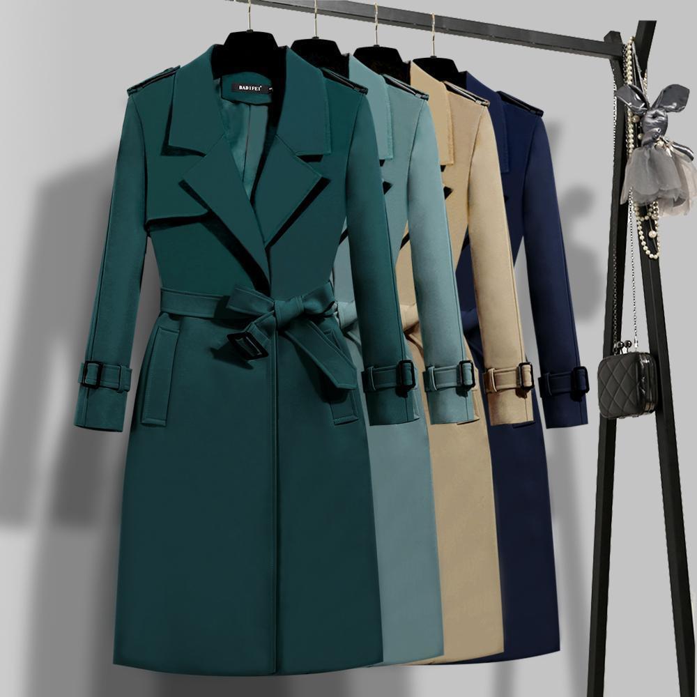 Collection of various coats on a rack with a focus on a teal coat.