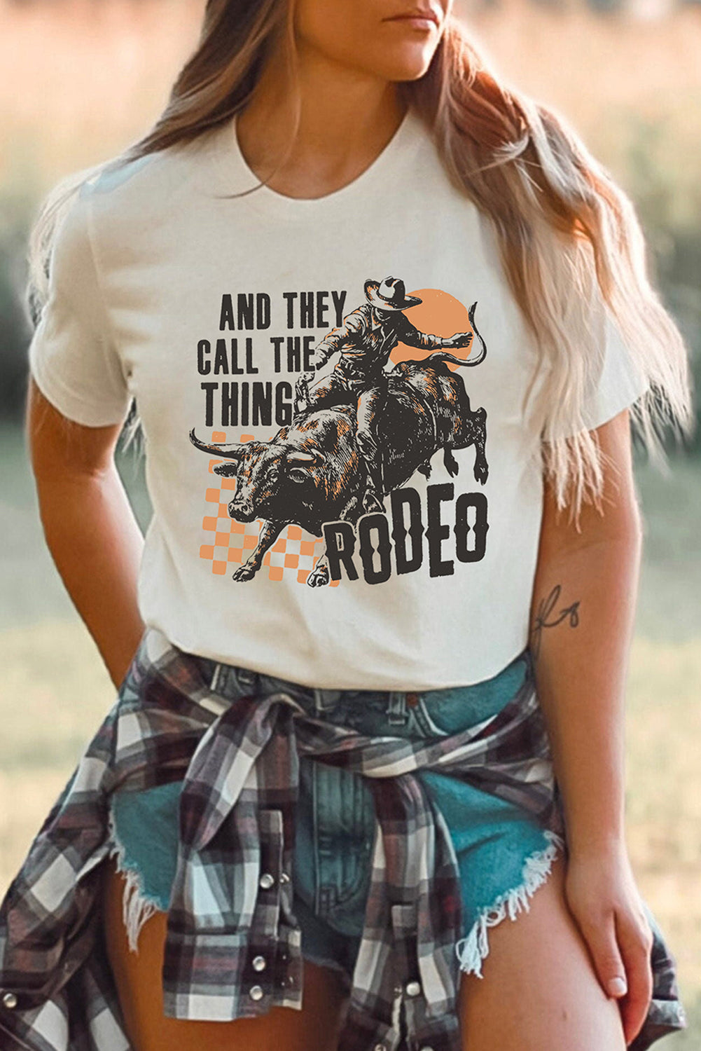 Person wearing a t-shirt with a graphic and text about rodeo
