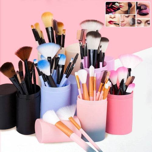 A collection of makeup brushes in various colors including pink, blue, black, and purple, displayed in cylindrical holders.