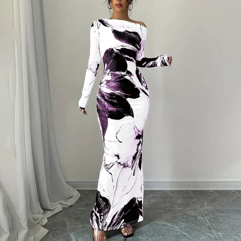 Woman wearing a long, off-shoulder dress with abstract floral pattern in white, black, and purple.
