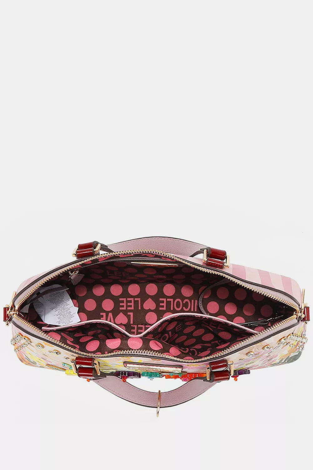 Brown and pink polka dot purse interior with a double pocket