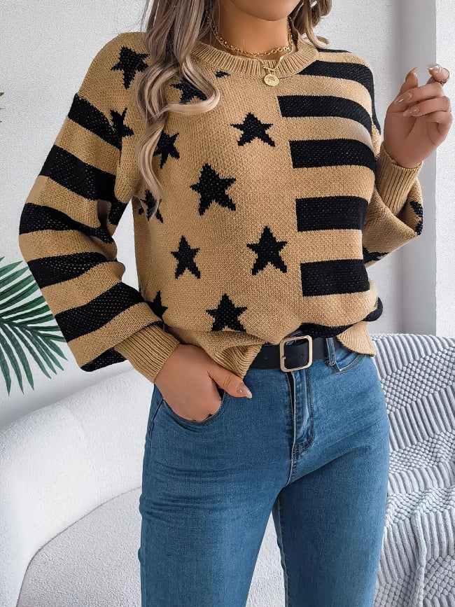 Person wearing a beige sweater with black stars and stripes pattern
