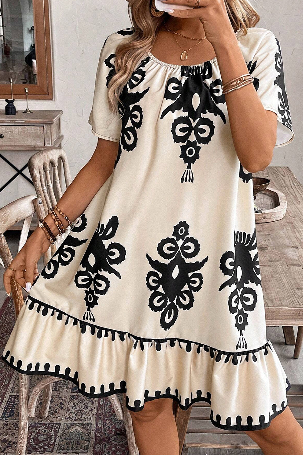 Woman wearing a white dress with black patterns 