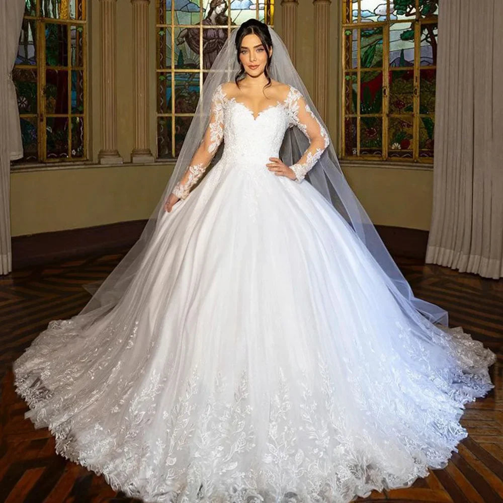 Woman in a white wedding dress with long sleeves and a veil 