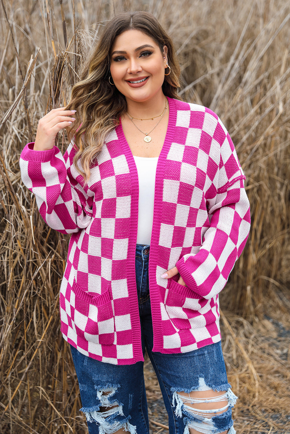 Woman wearing a pink and white checkered cardigan