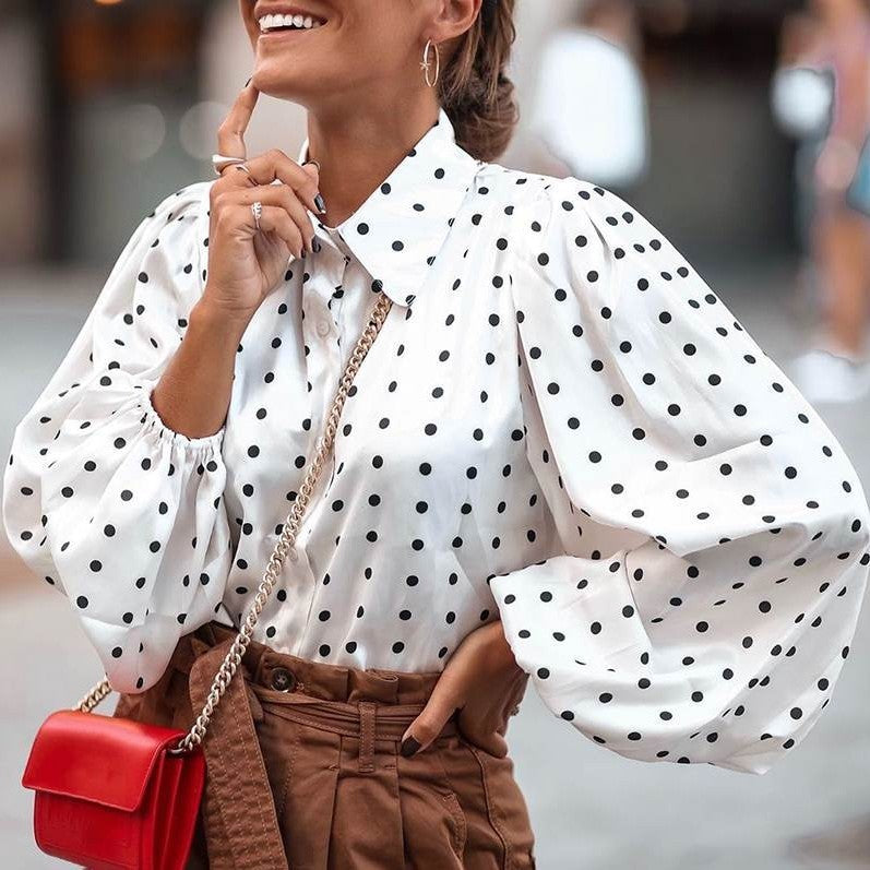 Woman wearing a white blouse with black polka dots 