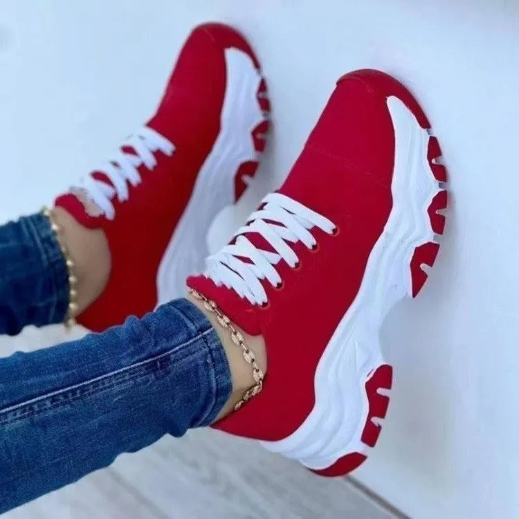 Red sneakers with white soles and laces