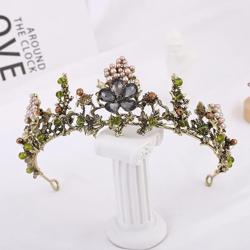 Decorative headpiece with floral and pearl details on a white stand against a light background.
