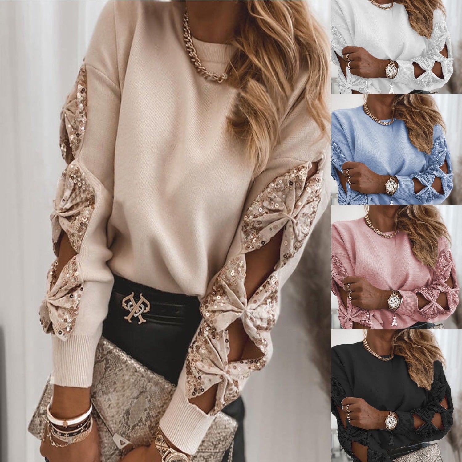 Beige sweater with cut-out sleeves and embellishments, worn by a person.