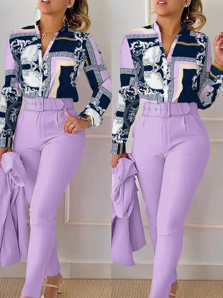Woman wearing a patterned top and lavender pants holding a matching jacket.