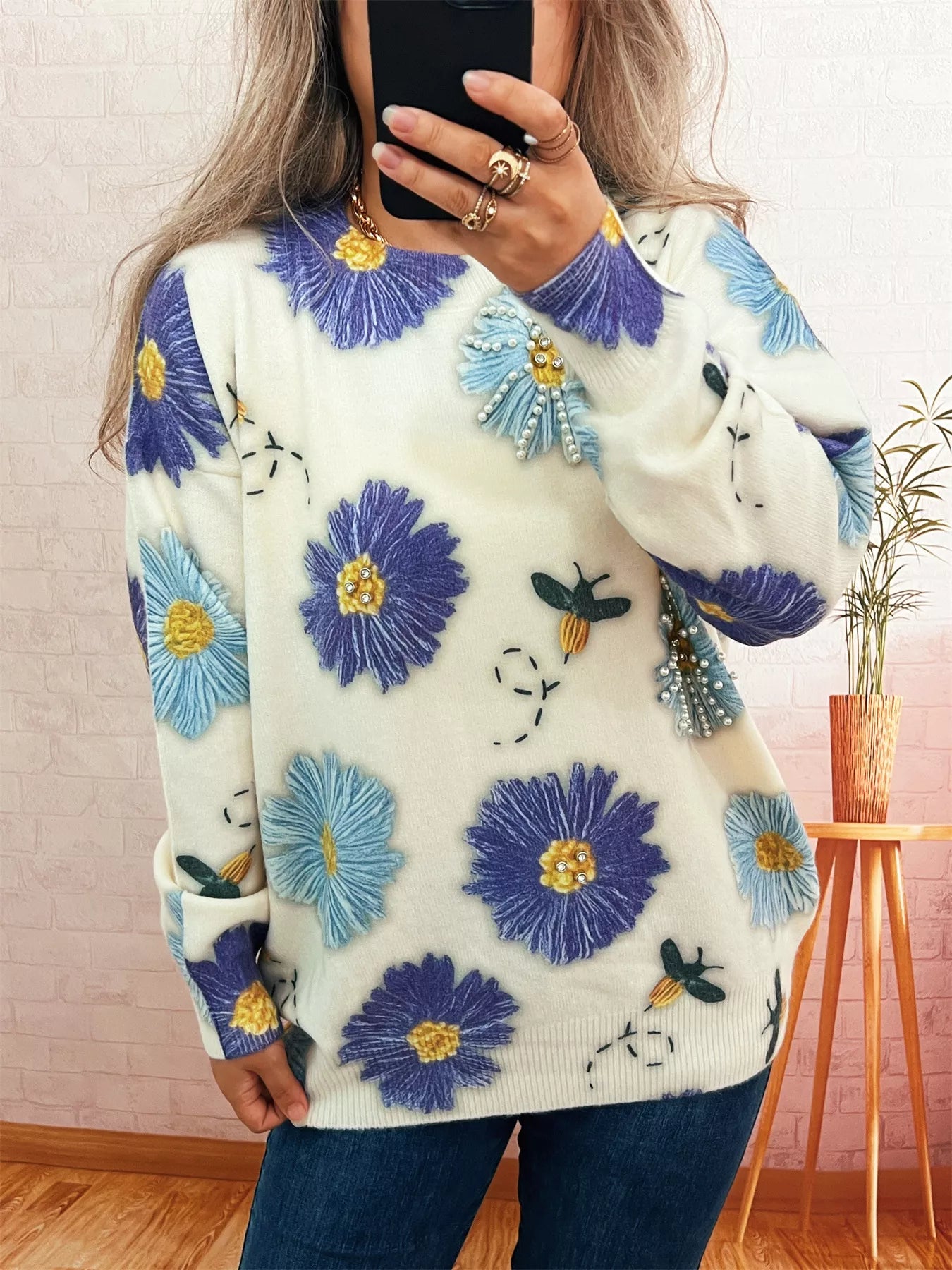 White sweater with large pearl embellished flowers and circling bees