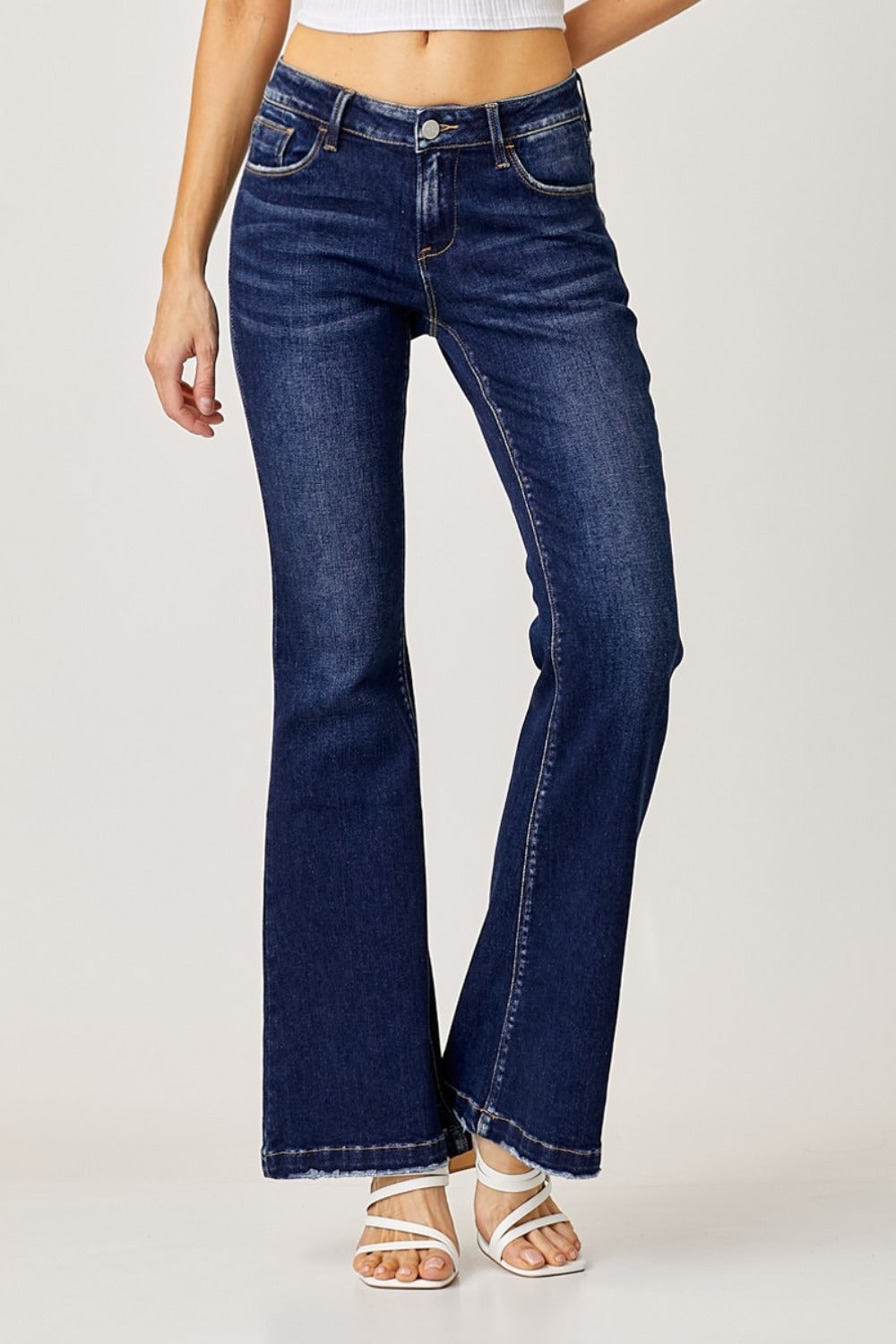 A pair of full-size low-rise flare jeans with a washed color and pockets