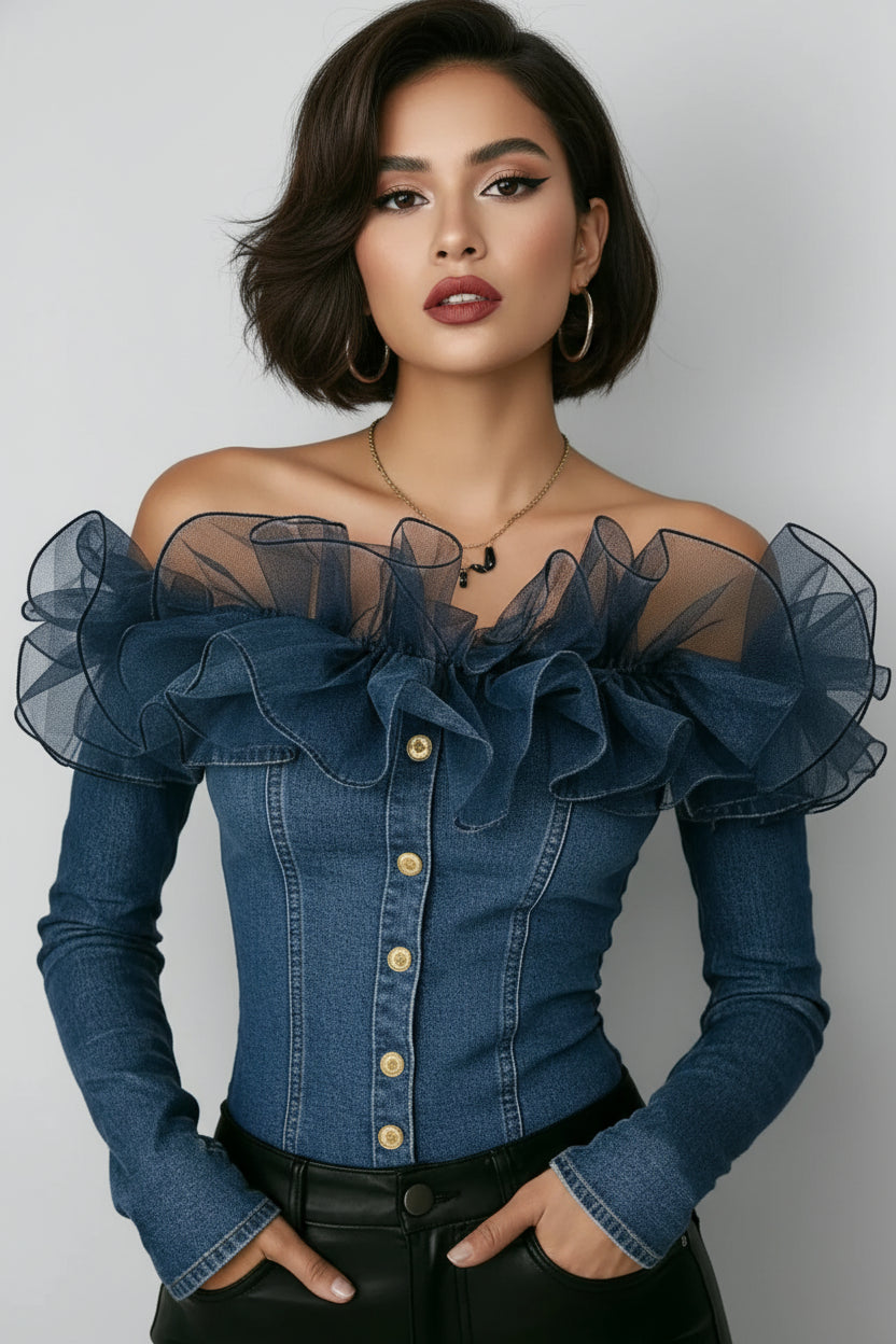 A woman wearing a blue denim off-the-shoulder top with sheer mesh ruffle sleeves, gold-tone buttons down the front, and black leather pants, shown from the neck to the hips against a plain light background.