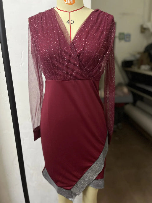Maroon dress on a mannequin with sheer sleeves 