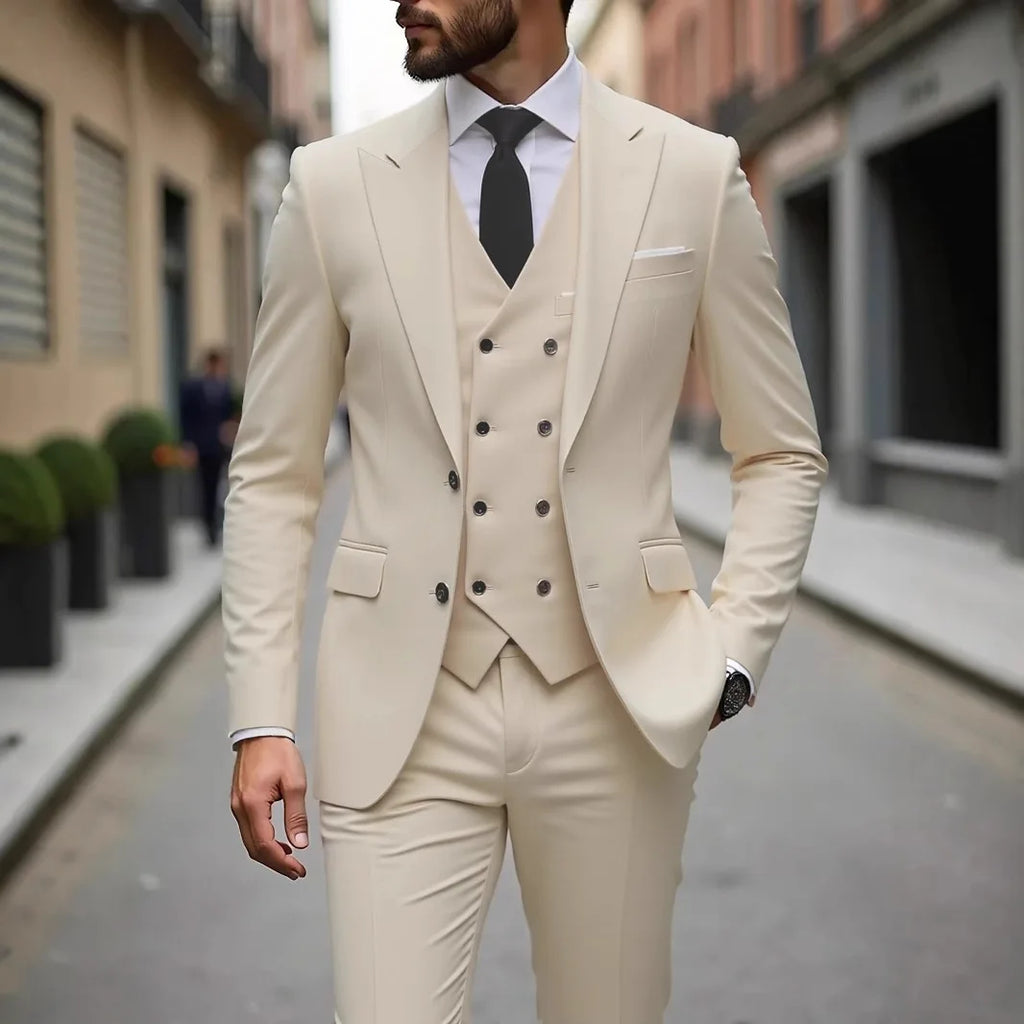 Man wearing a beige suit with a black tie on a city street.