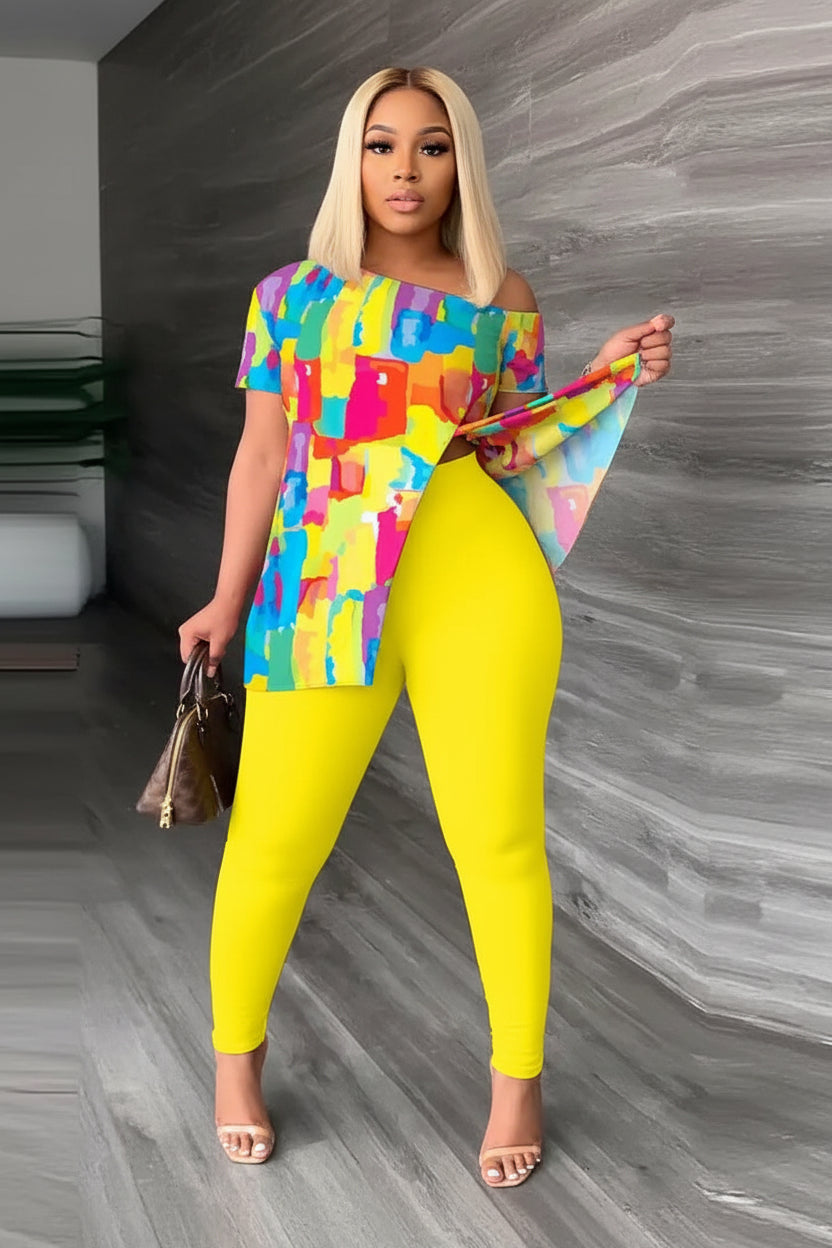 Woman wearing a colorful top and yellow leggings on a gray floor.