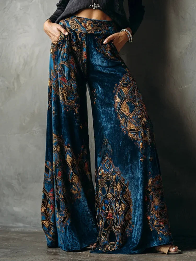 Blue patterned pants worn by a person against a gray background