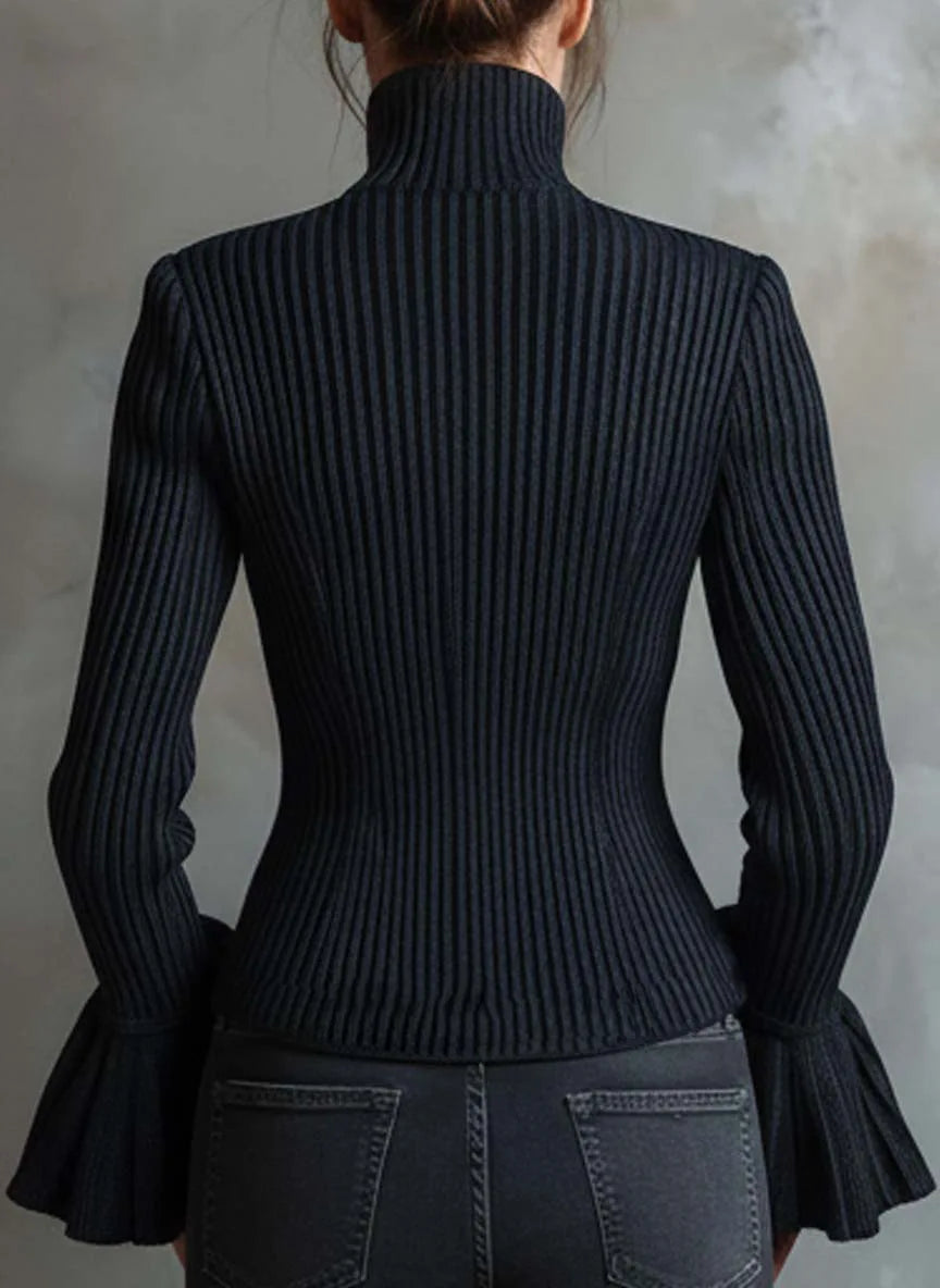 Black ribbed turtleneck sweater worn by a person against a neutral background