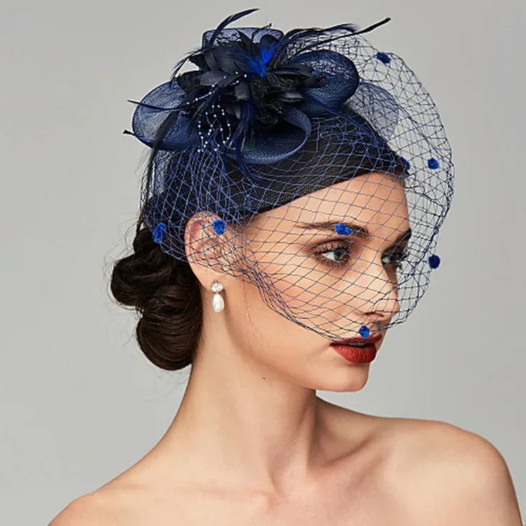 Woman wearing a navy blue fascinator with flowers and netting