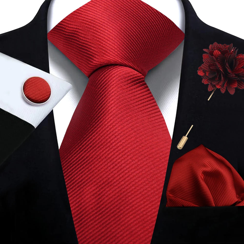 Red tie with matching cufflinks, handkerchief, flower pin