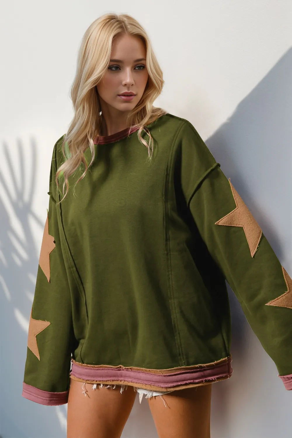 Woman wearing a green sweatshirt with star patterns