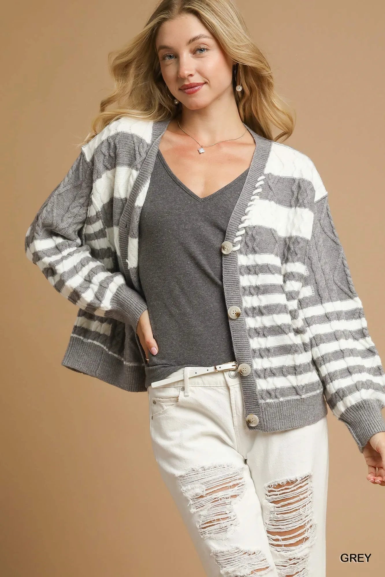 Woman wearing a gray and white striped cardigan 