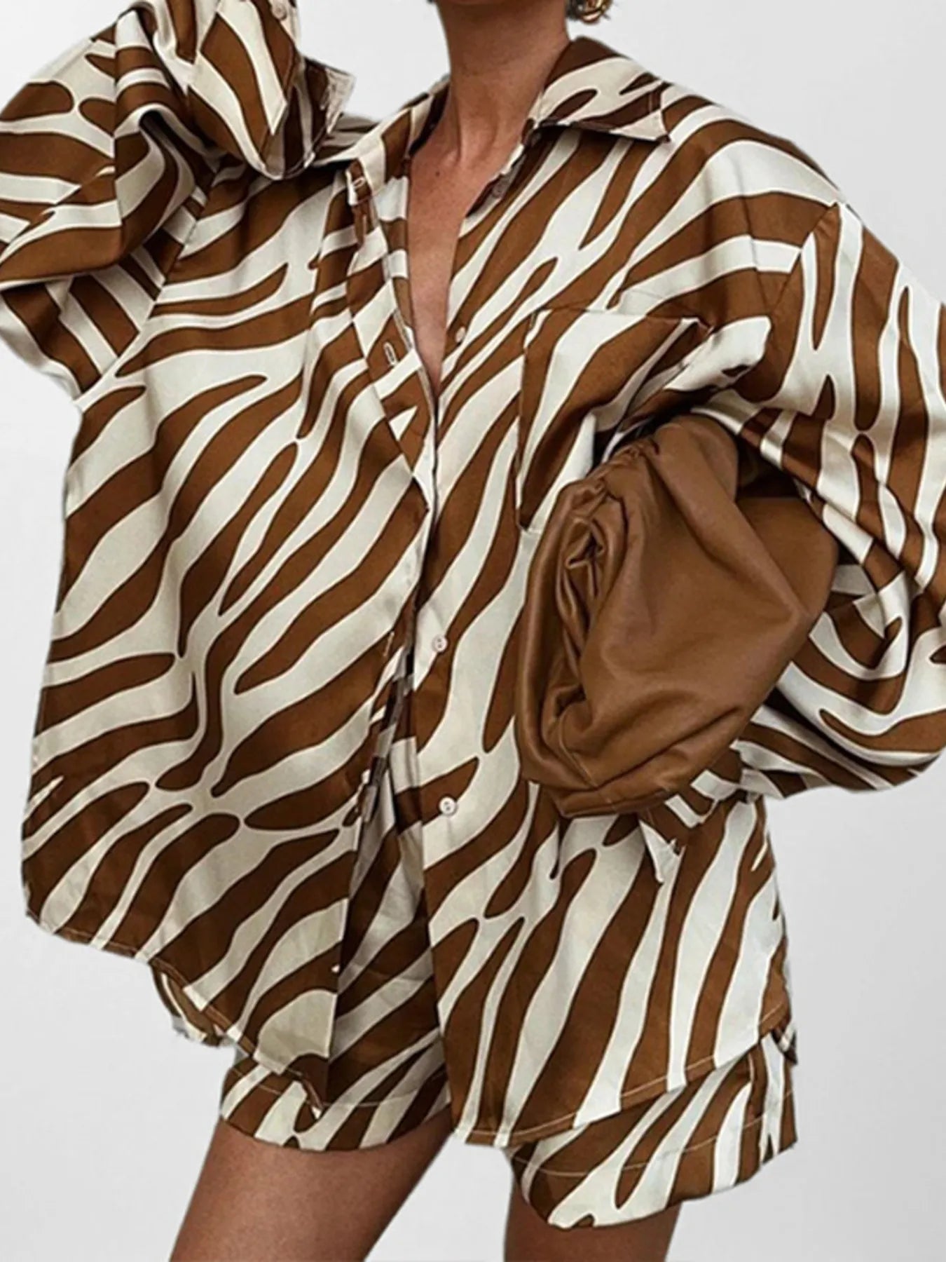 Zebra print shorts and long sleeve button up shirt outfit with brown and white pattern
