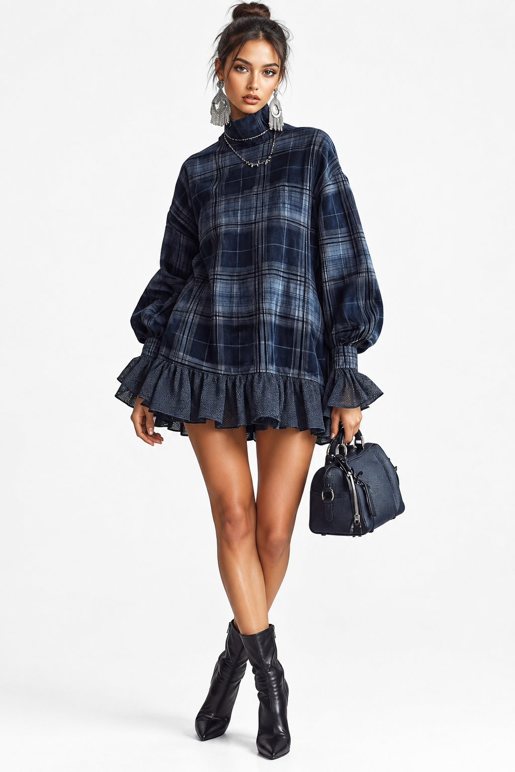 A model wearing a navy blue and black plaid turtleneck mini dress with balloon sleeves and a ruffled hem, styled with black ankle boots and a small black handbag against a light gray studio background.