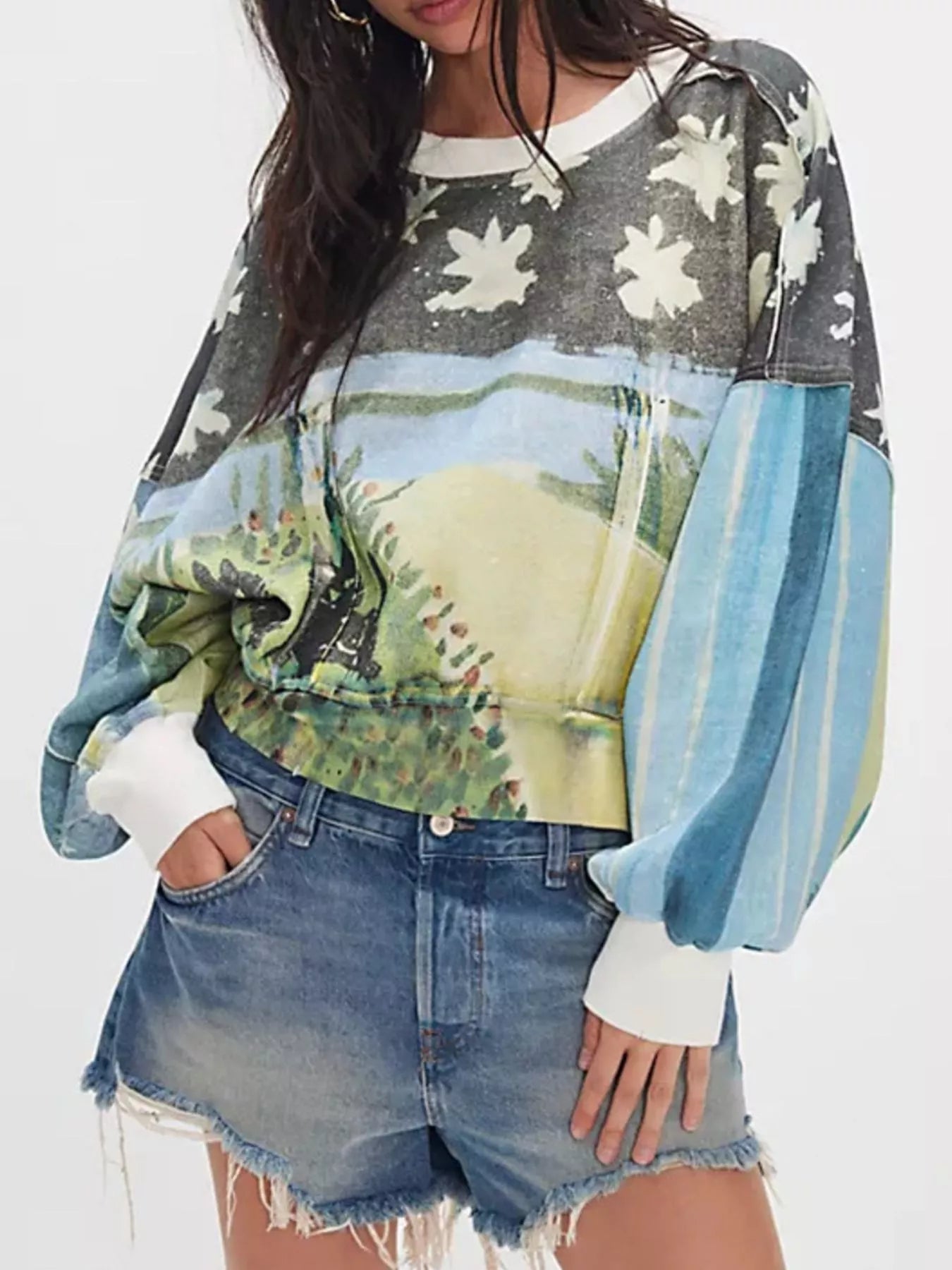 Person wearing a colorful sweater with nature-themed design 