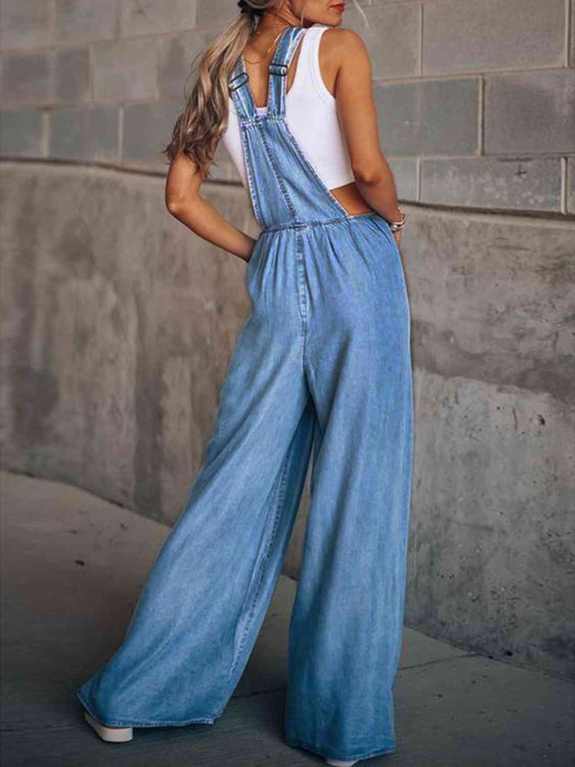 Back view of light blue wide leg denim overalls